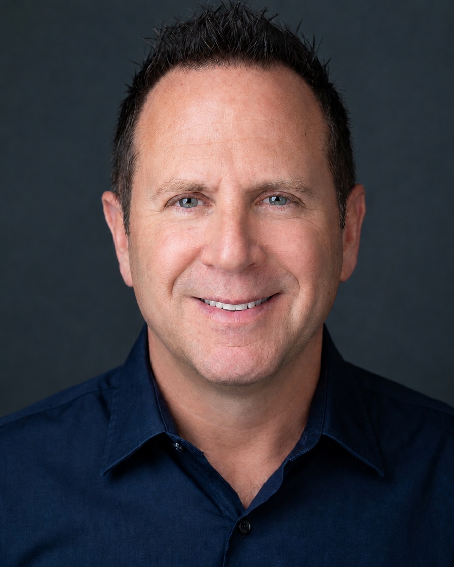 Pol Klein, smiling, in a navy shirt.